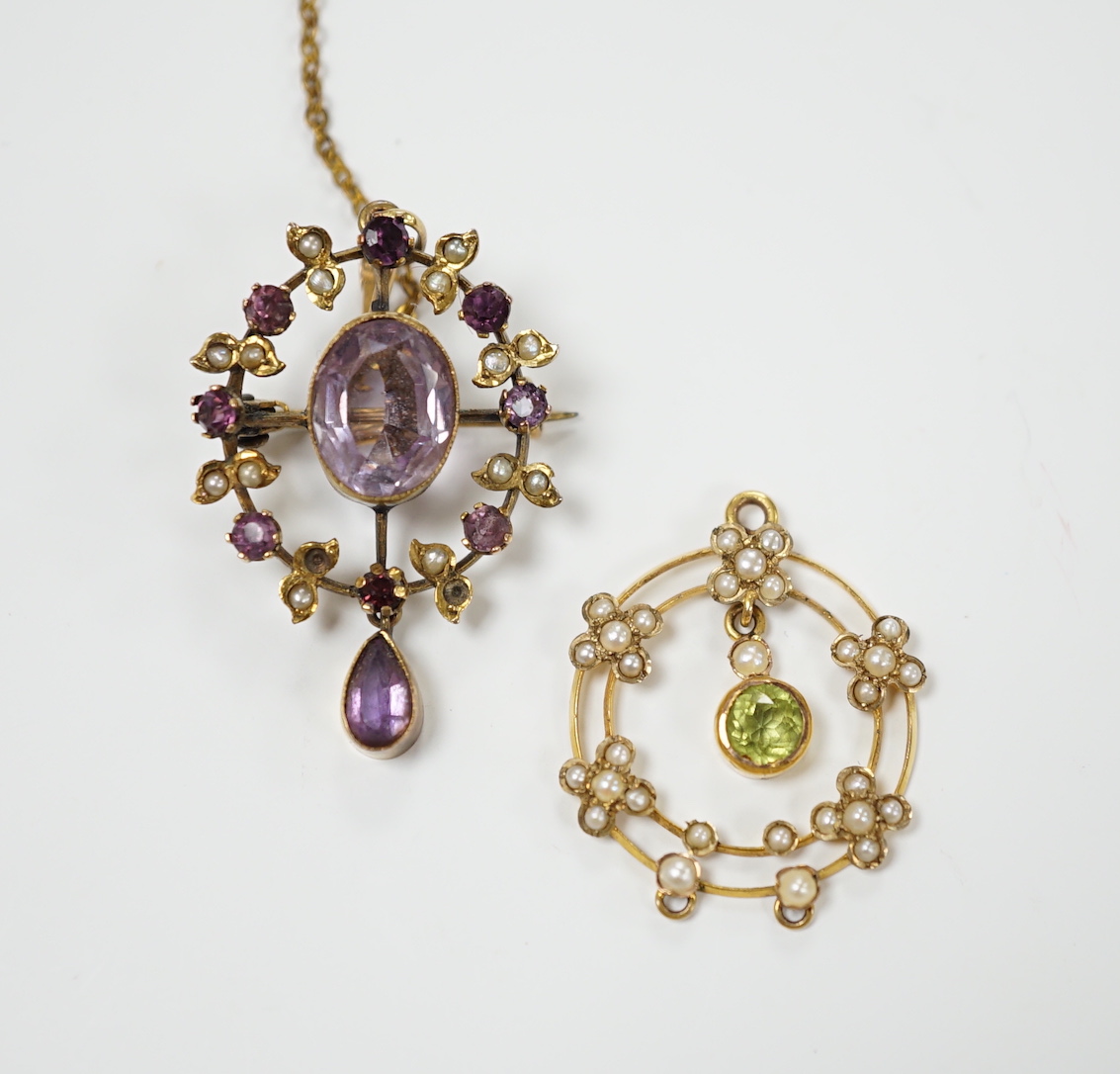 An early 20th century 9ct, peridot and seed pearl set drop pendant, 25mm and one other yellow metal and gem set pendant.